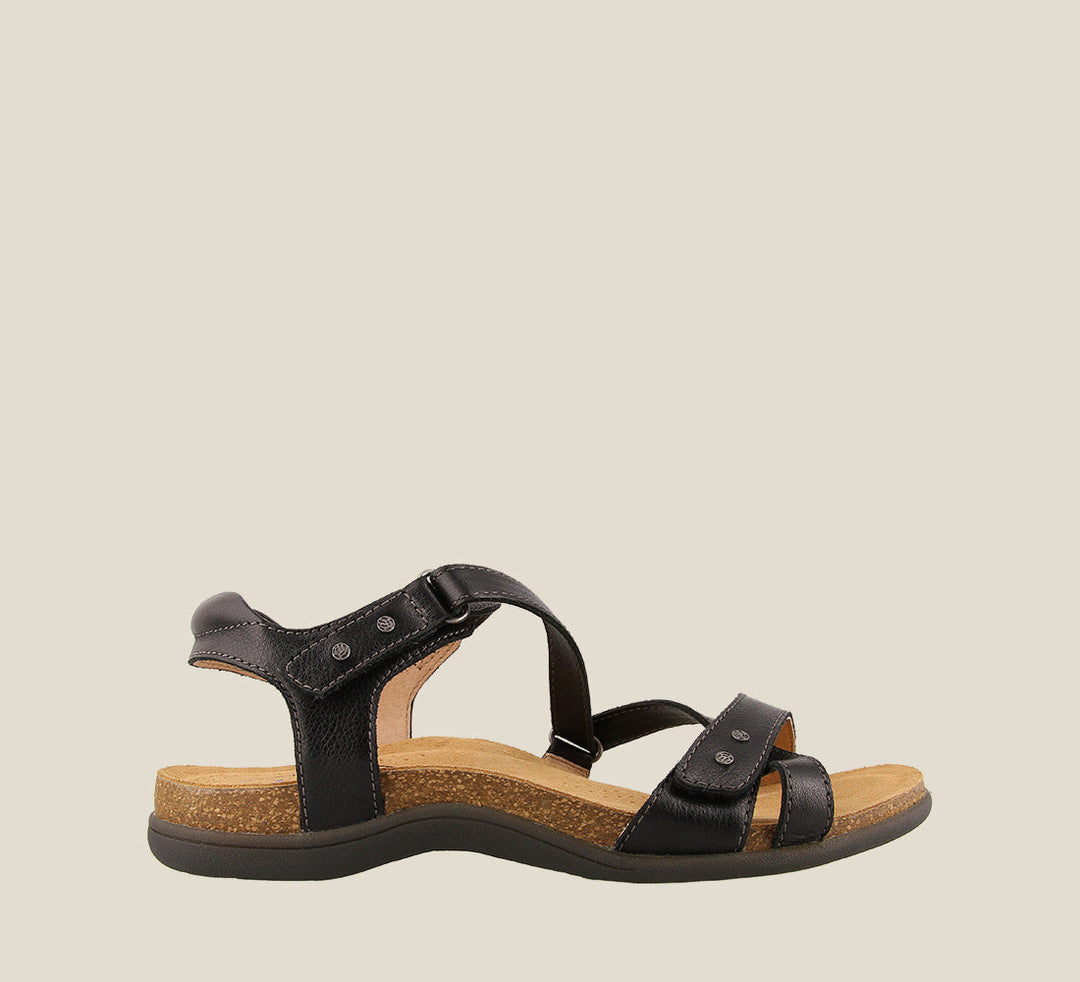 Outside angle of Grand Z Black Z strap sandal on our cork footbed featuring soft leather complete adjustability metal rivets and a rubber outsole. - size 6
