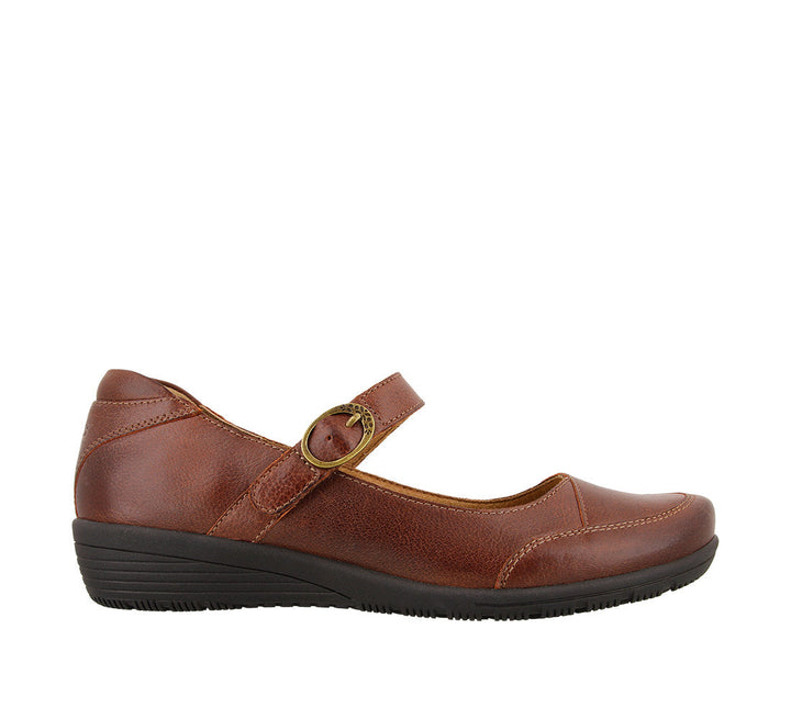 Outside angle of Cognac Leather mary jane featuring a hook and loop strap closure and rubber outsole - size 6