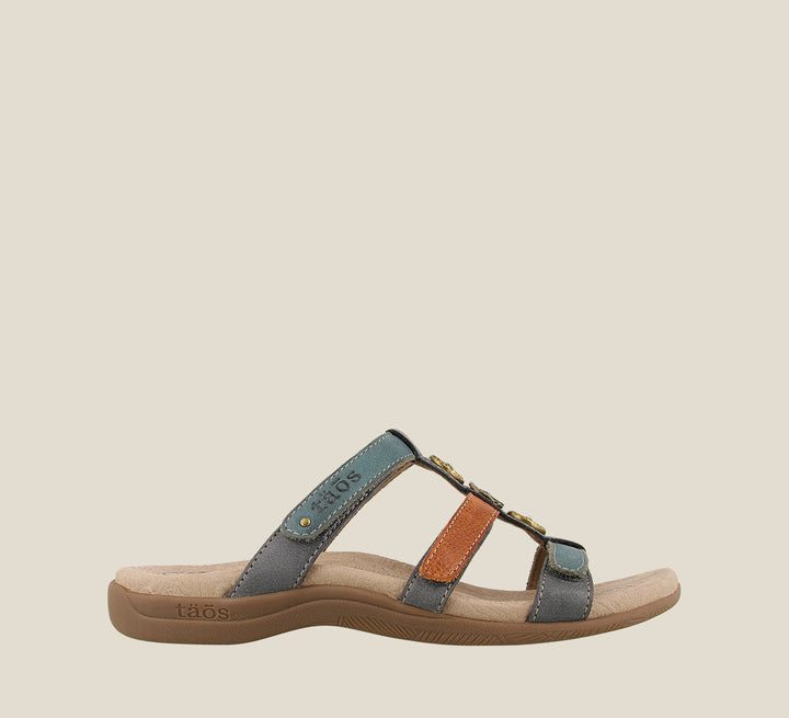 Outside angle of Prize 4 Teal Multi Casual leather slide sandal with pounded medallions jewel hardware hook and loop straps and a rubber outsole. - size 6